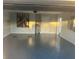 Spacious garage featuring a freshly painted interior, water heater, and sleek gray epoxy flooring at 4205 Morning Breeze Ct, Tampa, FL 33619