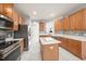 Modern kitchen featuring stainless steel appliances, wood cabinets, and a center island at 4205 Morning Breeze Ct, Tampa, FL 33619