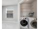 Laundry room featuring new washer and dryer and white wire shelving at 4205 Morning Breeze Ct, Tampa, FL 33619