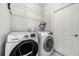 Close up of laundry room featuring new washer and dryer and white wire shelving at 4205 Morning Breeze Ct, Tampa, FL 33619