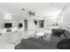 Spacious living room featuring tile floors, a ceiling fan, and abundant natural light at 4205 Morning Breeze Ct, Tampa, FL 33619