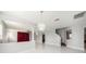 Open-concept living space with a modern chandelier, red curtains, and archways at 4205 Morning Breeze Ct, Tampa, FL 33619