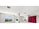 Bright living room with an elegant chandelier, large windows, and sleek white marble flooring at 4205 Morning Breeze Ct, Tampa, FL 33619