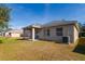 Tan house exterior with covered patio at 4407 Huddlestone Dr, Wesley Chapel, FL 33545