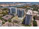 Aerial view of a residential complex with a pool, landscaping, and nearby buildings at 450 Knights Run Ave # 1102, Tampa, FL 33602