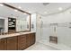 Spacious bathroom with dual vanities, glass shower, and built-in shelves at 450 Knights Run Ave # 1102, Tampa, FL 33602
