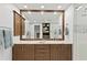 Modern bathroom featuring double vanities, a large mirror, and a walk-in shower at 450 Knights Run Ave # 1102, Tampa, FL 33602