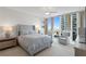 Bedroom with city views through large windows at 450 Knights Run Ave # 1102, Tampa, FL 33602