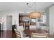 Dining area adjacent to the kitchen with a round table, chairs, and a unique light fixture at 450 Knights Run Ave # 1102, Tampa, FL 33602