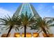 Modern high-rise building with palm trees at the entrance at 450 Knights Run Ave # 1102, Tampa, FL 33602