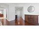 Elegant hallway with wood flooring, a round mirror, and console table at 450 Knights Run Ave # 1102, Tampa, FL 33602