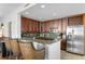 This kitchen features dark wood cabinets, stainless steel appliances, and a granite countertop at 450 Knights Run Ave # 1102, Tampa, FL 33602