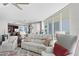 Living room featuring plush seating, large windows, and access to the dining area at 450 Knights Run Ave # 1102, Tampa, FL 33602