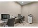 Small home office with two computer workstations, printer, and office chairs at 450 Knights Run Ave # 1102, Tampa, FL 33602