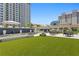Community green space with dining, seating, and a water feature at 450 Knights Run Ave # 1102, Tampa, FL 33602