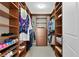Well-organized walk-in closet with wooden shelves, drawers, and hanging space at 450 Knights Run Ave # 1102, Tampa, FL 33602