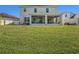 Two-story home with screened porch and large lawn at 5056 Inshore Landing Dr, Apollo Beach, FL 33572