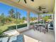Screened-in porch, patio furniture, and backyard view at 5056 Inshore Landing Dr, Apollo Beach, FL 33572