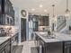 Modern kitchen with dark cabinets, stainless steel appliances, and a large island with granite countertop at 5056 Inshore Landing Dr, Apollo Beach, FL 33572
