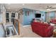 Upstairs loft with red seating area and a view to the laundry room at 5056 Inshore Landing Dr, Apollo Beach, FL 33572