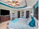 Main bedroom with a king-size bed, ceiling fan, and exercise equipment at 5056 Inshore Landing Dr, Apollo Beach, FL 33572
