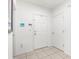 Bright entryway with white walls, tile flooring, and a conveniently placed key holder at 5193 Deltona Blvd, Spring Hill, FL 34606