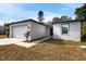 Charming single-story home with a well-maintained lawn, attached garage, and inviting front entrance at 5193 Deltona Blvd, Spring Hill, FL 34606
