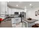 Updated kitchen featuring white cabinets, stainless appliances, and a cozy island with seating at 5193 Deltona Blvd, Spring Hill, FL 34606