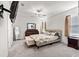 Spacious main bedroom featuring a ceiling fan and an upholstered bed at 5193 Deltona Blvd, Spring Hill, FL 34606
