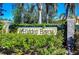 Hidden Bayou community entrance sign, adorned with lush landscaping at 7974 Tasso Ct, Seminole, FL 33777