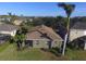 Home aerial showcasing landscaping, neutral paint, screened in porch and surrounding neighborhood at 8451 Karpeal Dr, Sarasota, FL 34238