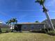 Charming home with a well-maintained lawn, screened in porch and lush landscaping at 8451 Karpeal Dr, Sarasota, FL 34238