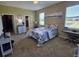 Comfortable bedroom with natural light and a view of the pond at 8451 Karpeal Dr, Sarasota, FL 34238