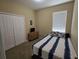 Bedroom with natural light, closet, carpet and stylish furniture at 8451 Karpeal Dr, Sarasota, FL 34238