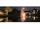 Night view of a community lake with a illuminated fountain, adding to the neighborhood's charm at 8451 Karpeal Dr, Sarasota, FL 34238