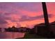 Beautiful sunset reflecting across the lake, showcasing the peaceful community setting at 8451 Karpeal Dr, Sarasota, FL 34238