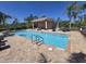 Community swimming pool featuring crystal clear water and ample lounge seating for residents to enjoy at 8451 Karpeal Dr, Sarasota, FL 34238