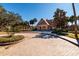 Clubhouse exterior with a paved driveway, surrounded by lush landscaping at 10200 Gandy N Blvd # 1313, St Petersburg, FL 33702