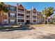 Exterior view of a two-story apartment building with balconies and palm trees at 10200 Gandy N Blvd # 1313, St Petersburg, FL 33702