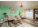 Bright living room featuring wood-look tile floors and colorful accents at 10200 Gandy N Blvd # 1313, St Petersburg, FL 33702