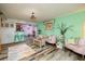Living room with wood-look tile, colorful walls, and view of the adjacent dining area at 10200 Gandy N Blvd # 1313, St Petersburg, FL 33702