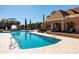 Large community pool with a curved design and brick pool house at 10200 Gandy N Blvd # 1313, St Petersburg, FL 33702