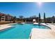 Community pool with steps for easy entry and a view of the apartment buildings at 10200 Gandy N Blvd # 1313, St Petersburg, FL 33702