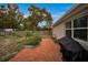 Brick patio, garden, and view of the backyard at 10463 Wren Rd, Brooksville, FL 34613