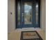 Dark blue front door featuring glass panels and a welcoming mat at 10463 Wren Rd, Brooksville, FL 34613