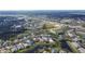 High-altitude aerial view of a neighborhood with homes, roads, and trees at 10707 Banfield Dr, Riverview, FL 33579