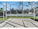 Screened patio with concrete floor, white fence, and green lawn at 10707 Banfield Dr, Riverview, FL 33579