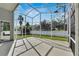 Large, screened patio with a white fence and lush green lawn at 10707 Banfield Dr, Riverview, FL 33579