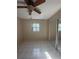 Well-lit bedroom with tiled floors and a ceiling fan at 10838 87Th Ave, Seminole, FL 33772