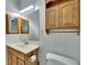 Bathroom with light wood vanity and medicine cabinets at 1535 Council Dr, Sun City Center, FL 33573